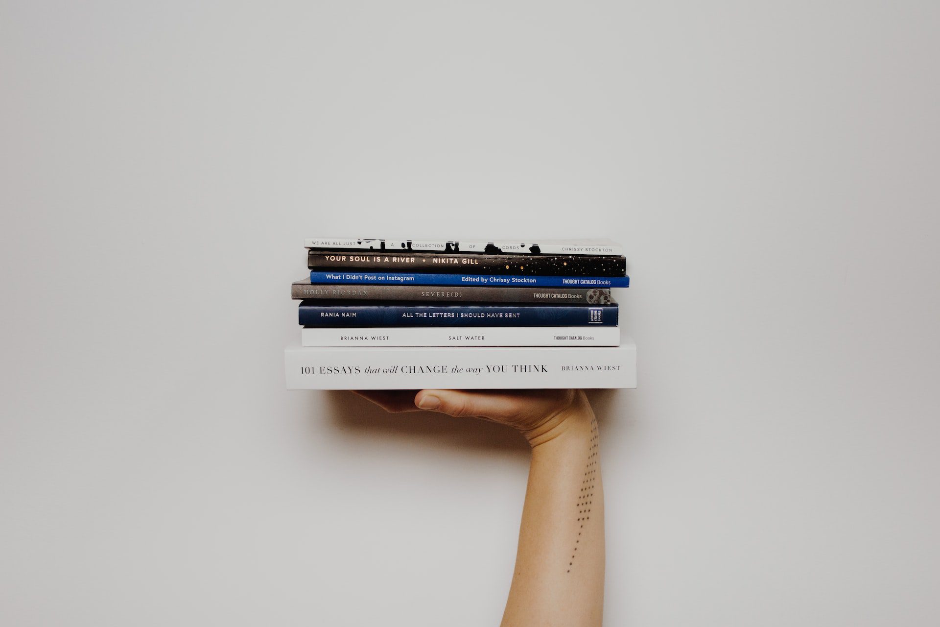 Books in hand - Photo by Thought Catalog on Unsplash