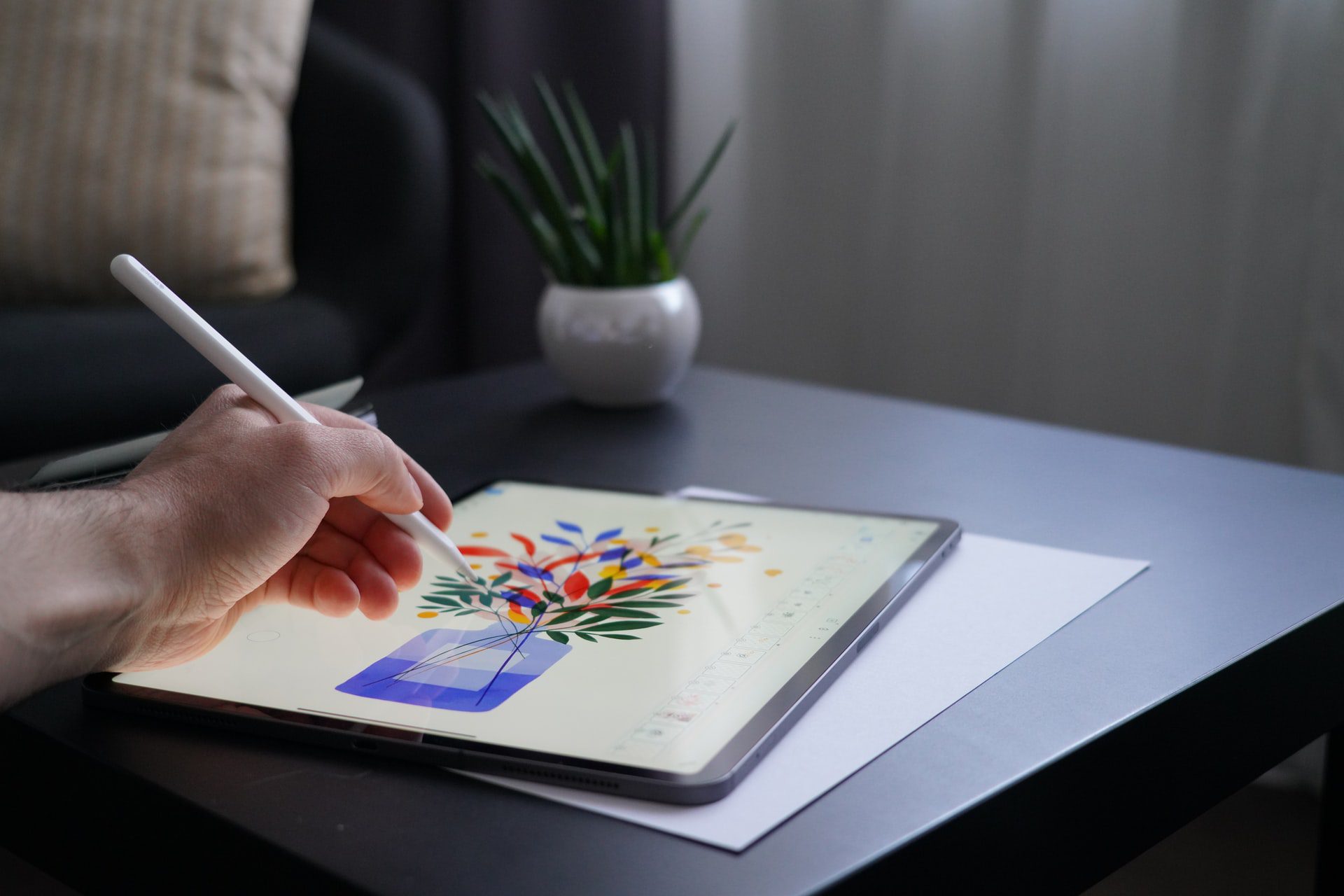 Illustrator working on book cover design on ipad - Photo by Sorin Gheorghita on Unsplash