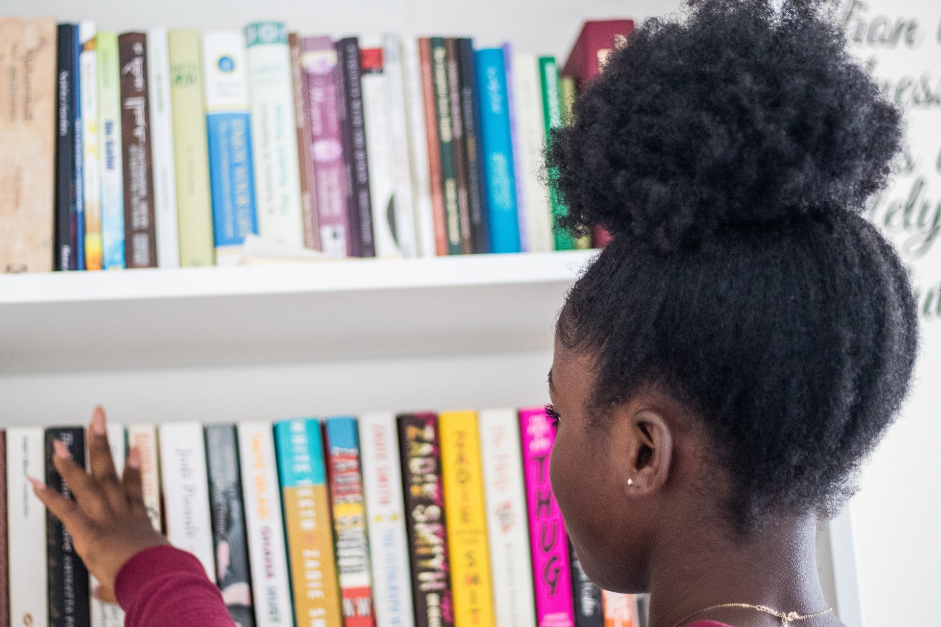 writing children's books - girl browsing books in book shop - Photo by Suad Kamardeen on Unsplash