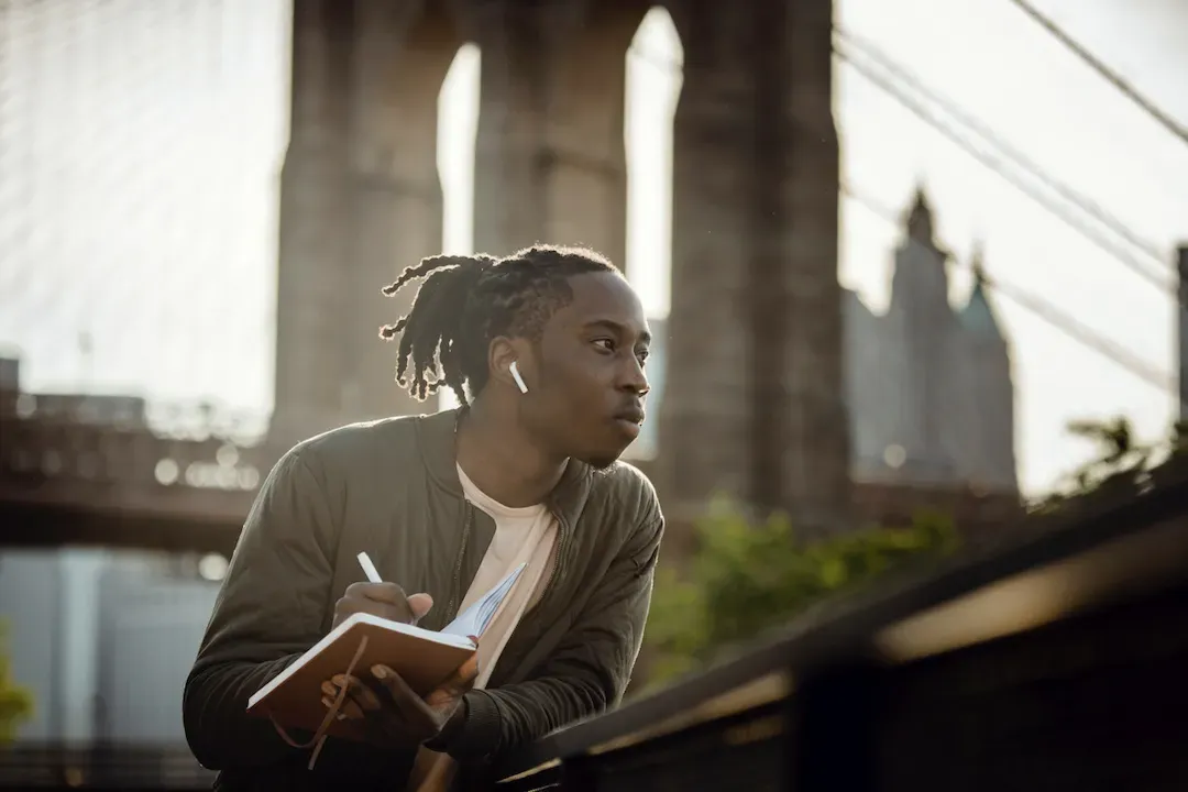 a man writing in a notebook